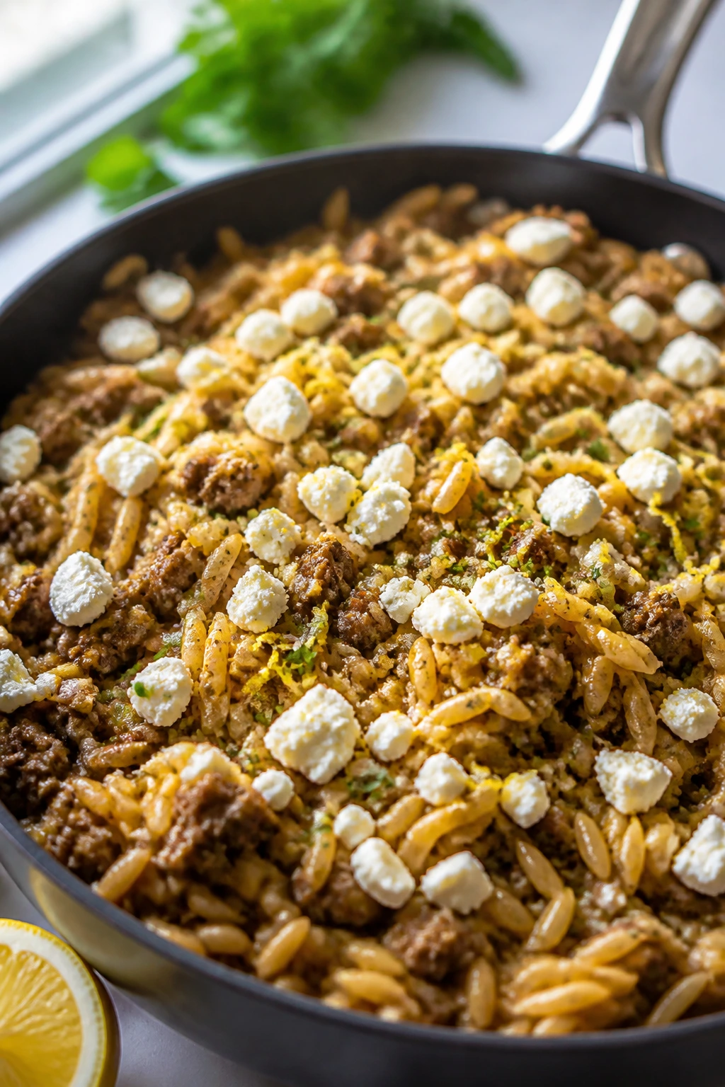 Orzo skillet with feta and lemon in a kitchen setting