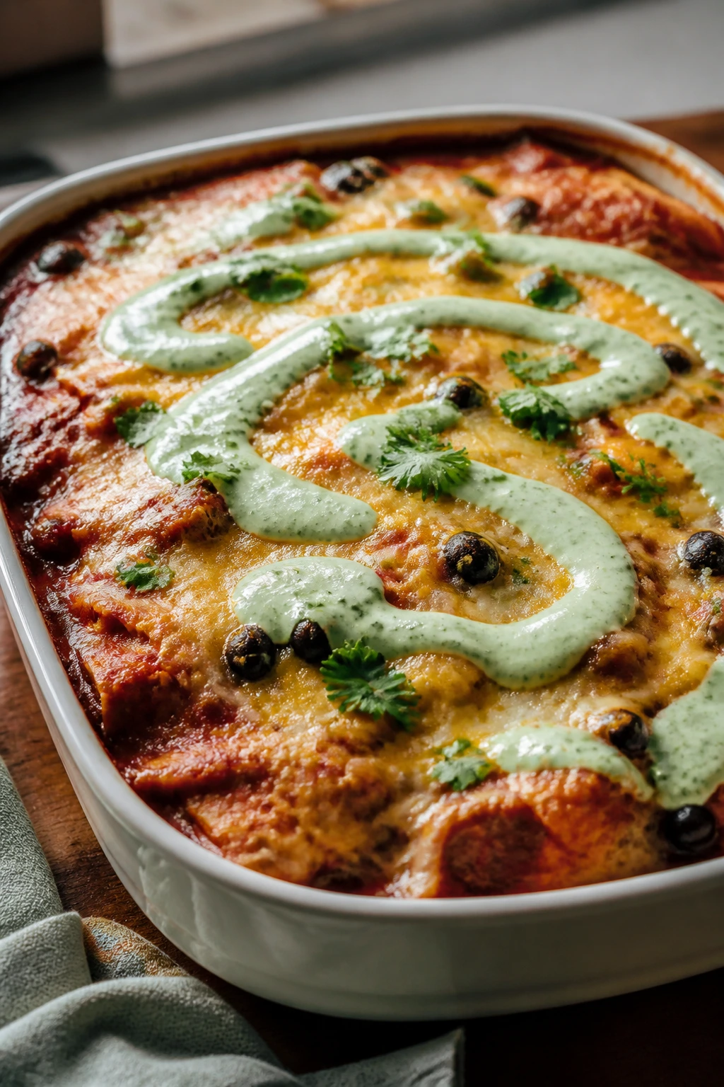 Bubbling Black Bean Enchilada Casserole with poblano cream on top