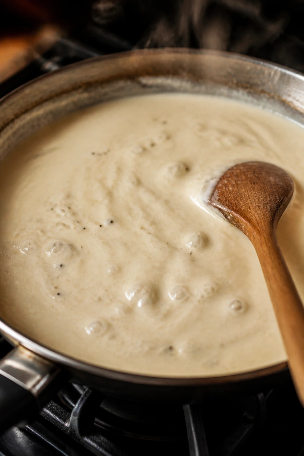 Cream sauce simmering gently in a pan on a stove