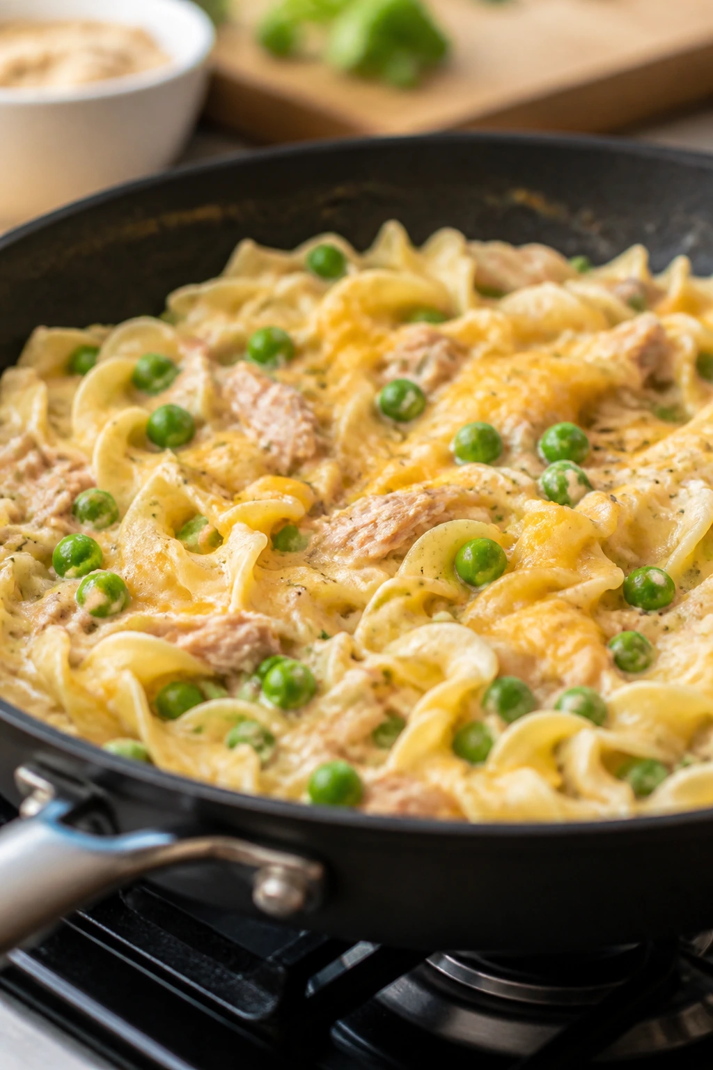 Creamy tuna noodle skillet with peas in a skillet on stove