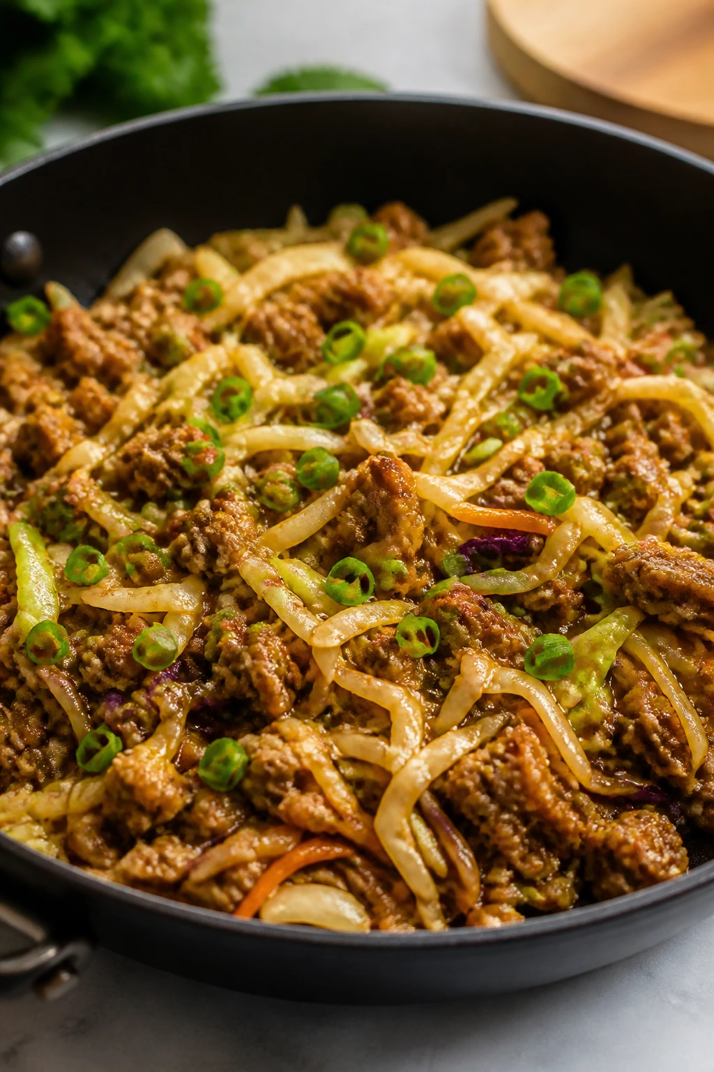 Skillet of egg roll in a bowl with pork and cabbage