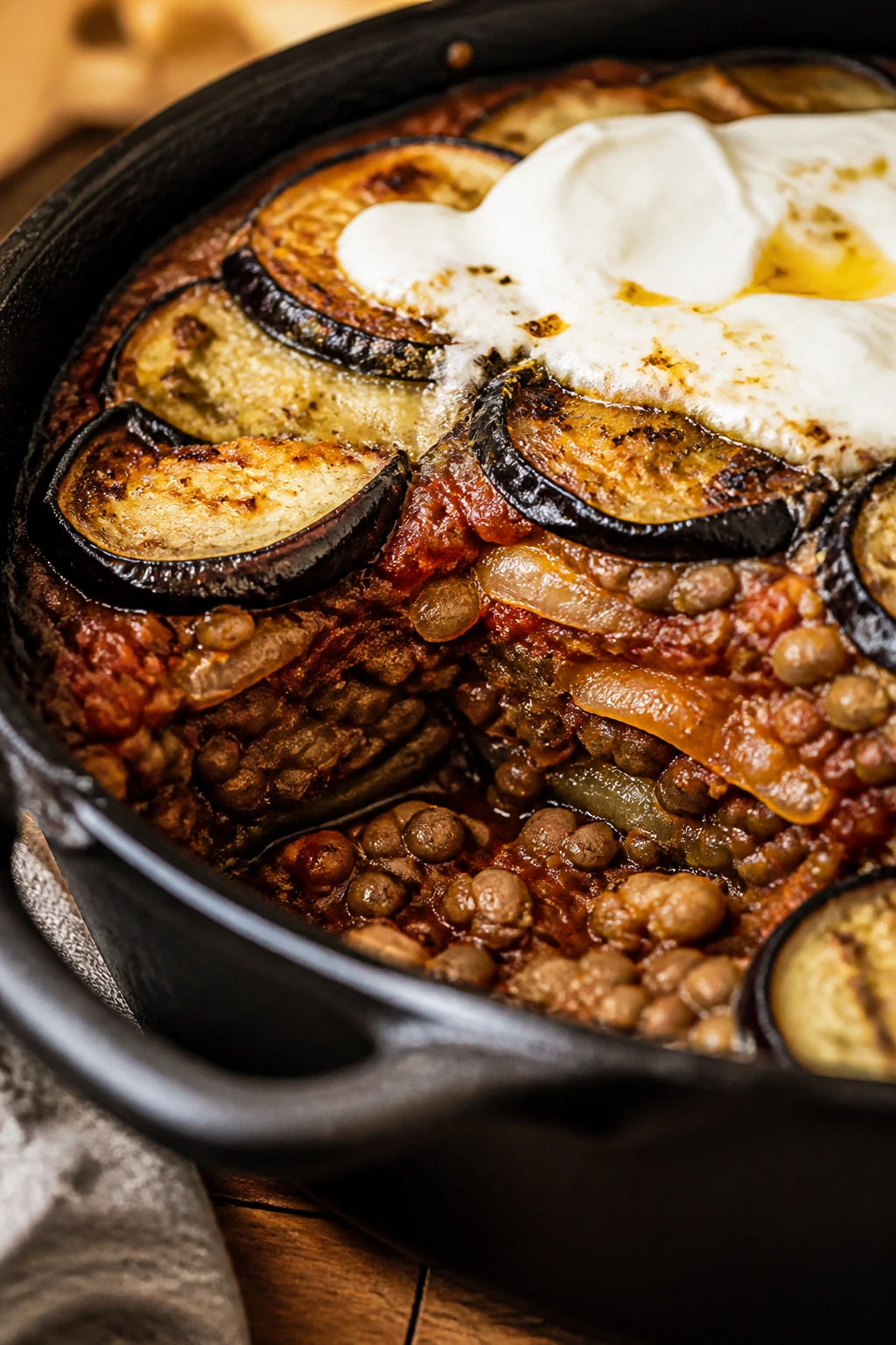 Close-up of skillet moussaka with eggplant and lentils