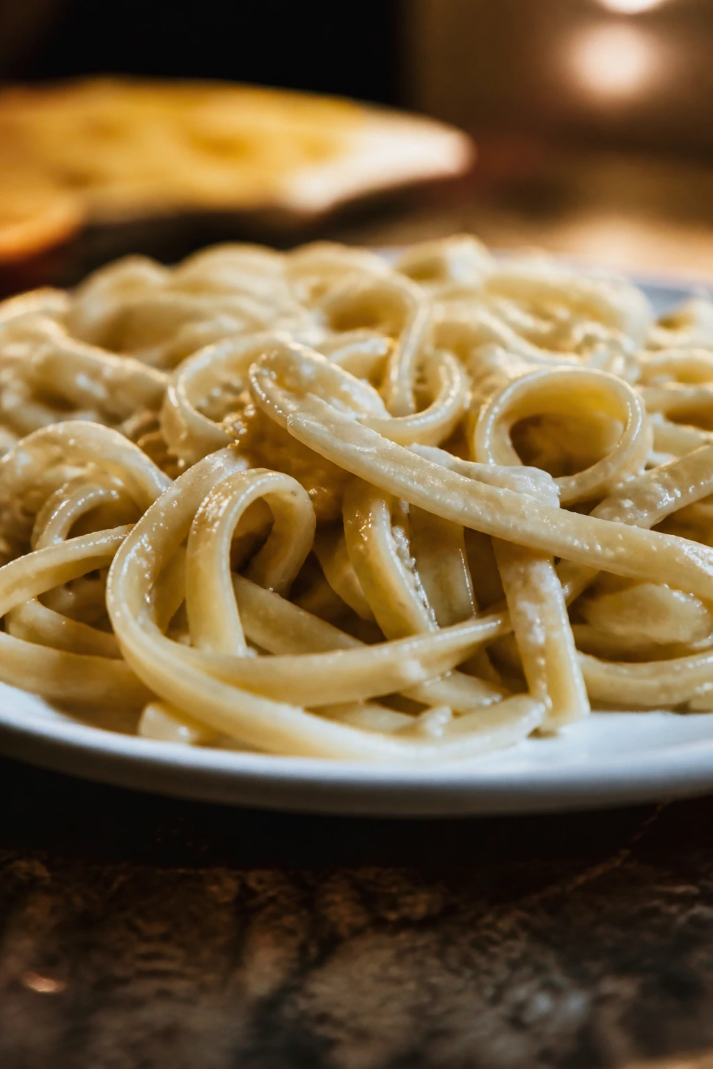 Close-up of mushy overcooked pasta on a plate.