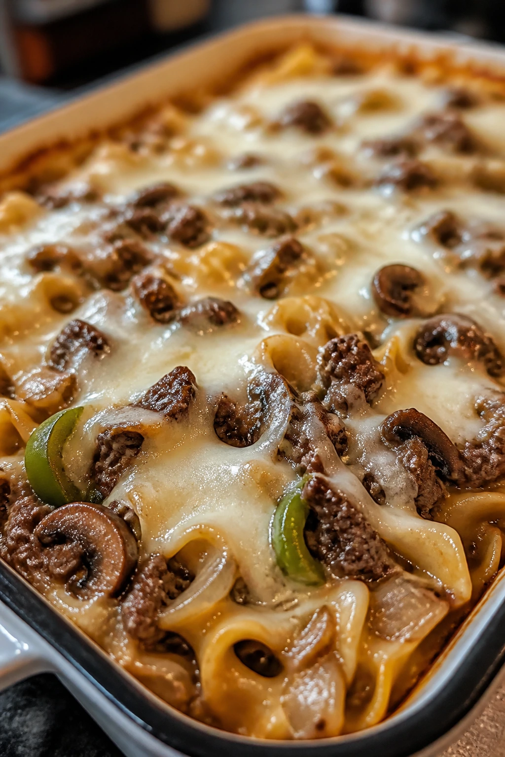 Close-up of Philly Cheesesteak Noodle Bake with melted provolone