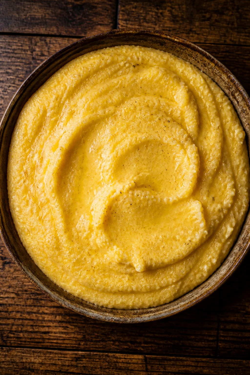 Top-down view of a table with a large dish of golden polenta