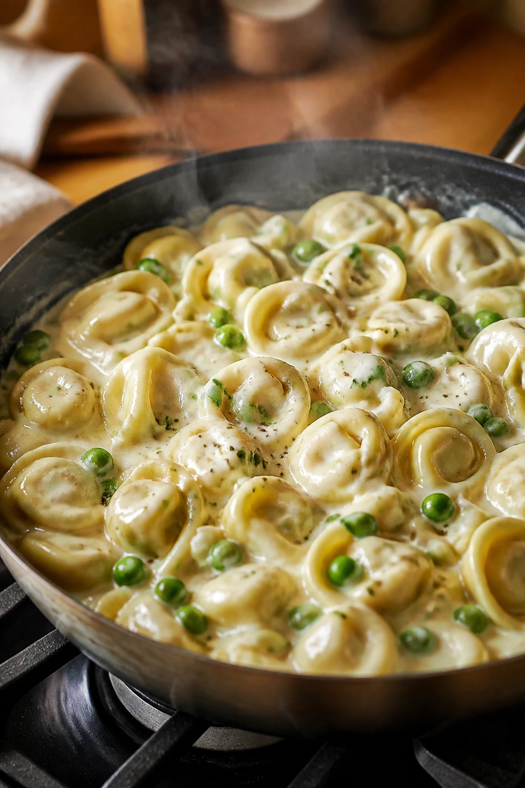Creamy tortellini with peas in a skillet