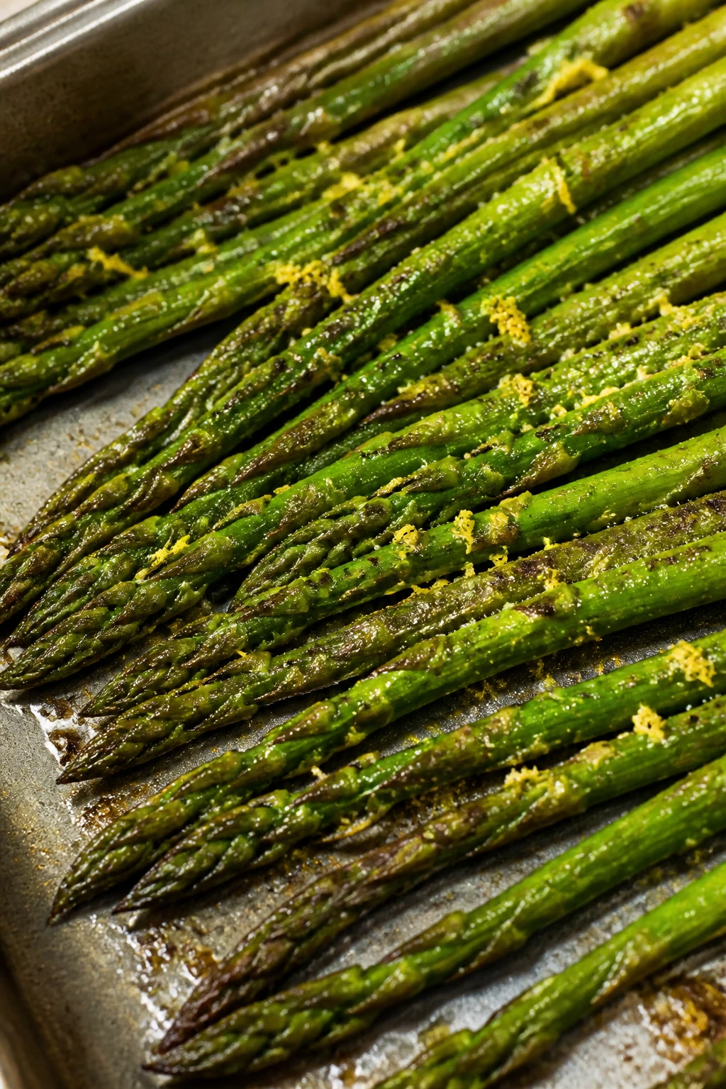 Close-up of lemon pepper asparagus on a baking sheet