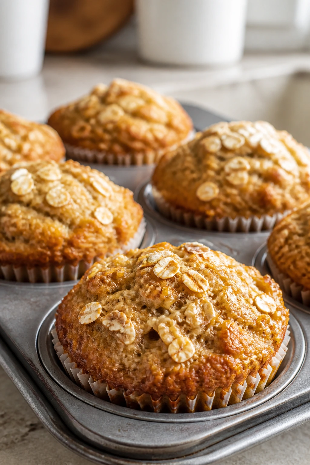 Close-up of banana oat muffins on a neutral counter
