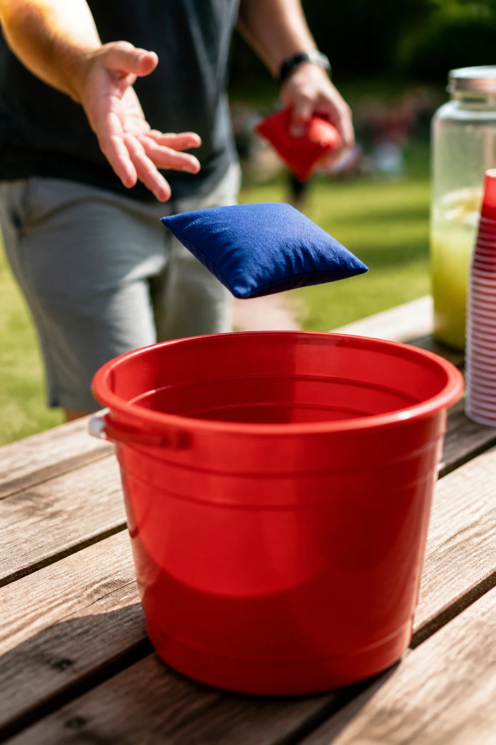 Beanbag toss into a bucket on a sunny backyard table