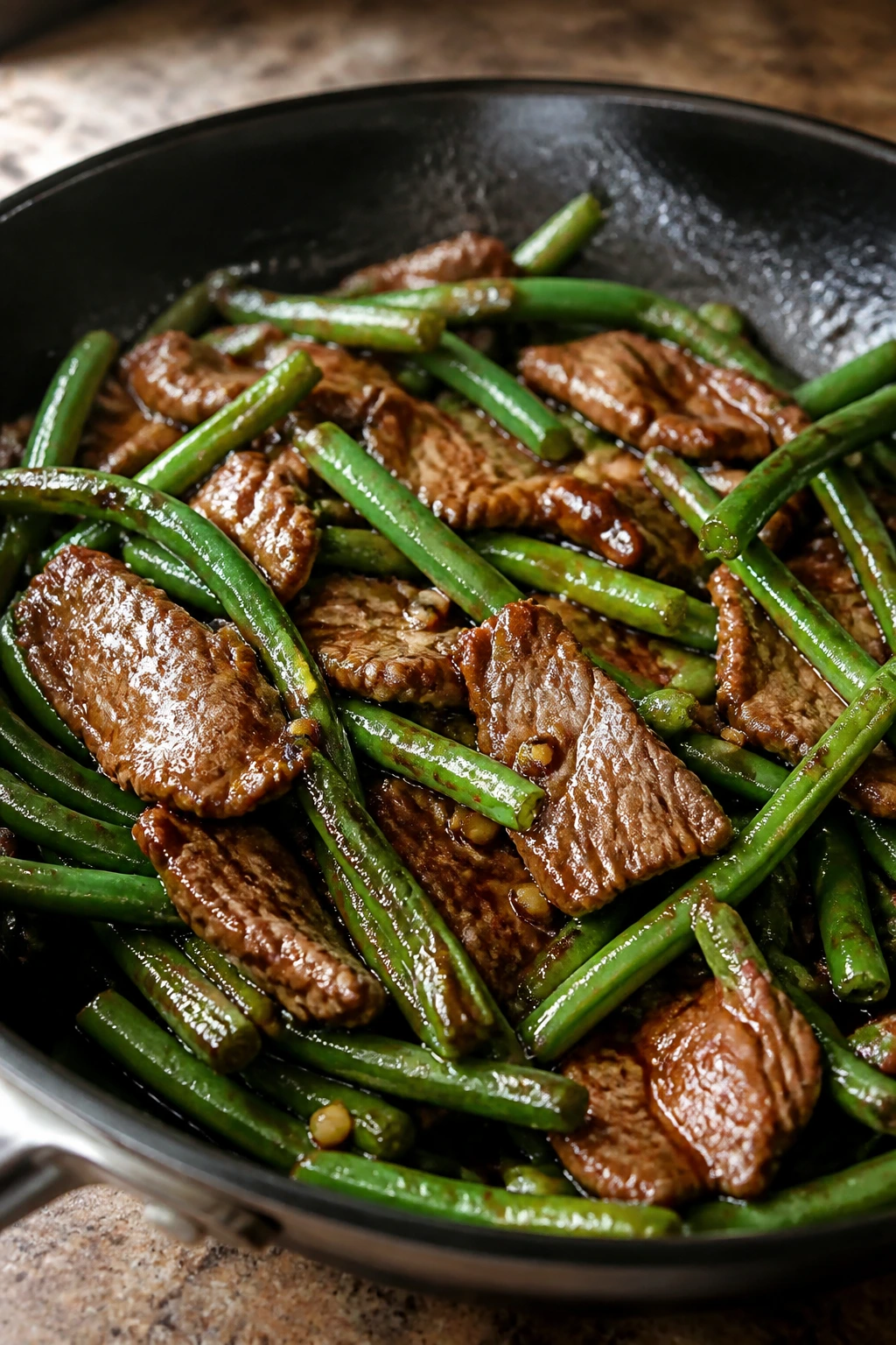Beef and long beans stir-fry in oyster sauce in a skillet