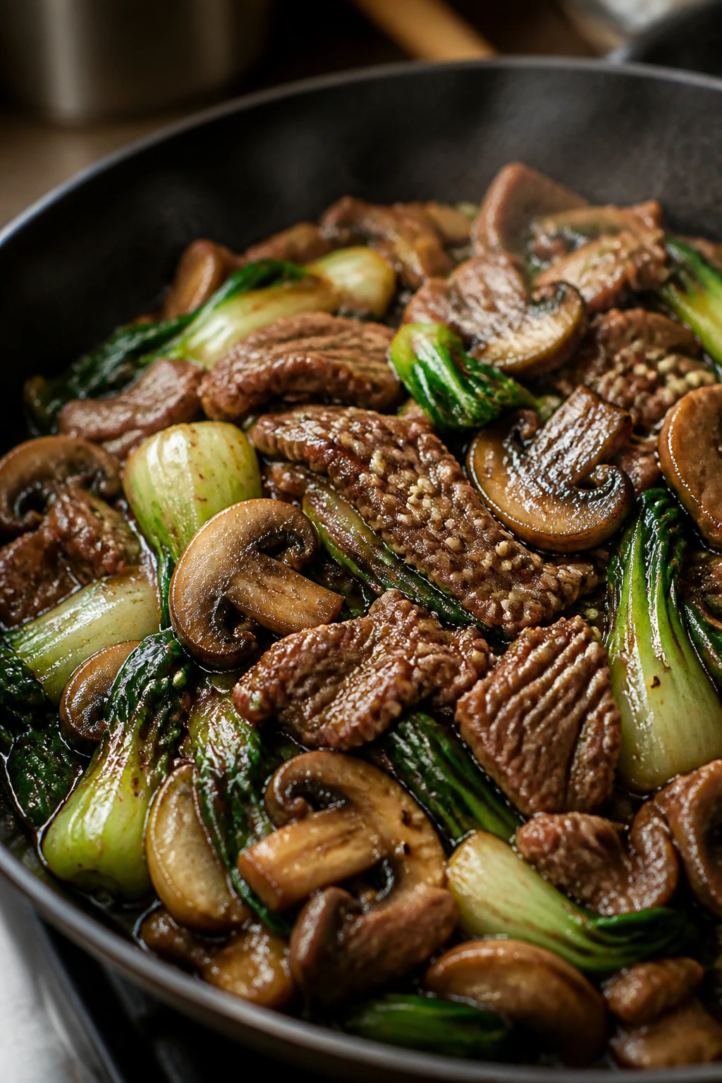 Close-up of beef and mushroom stir-fry with sesame seeds on a plate