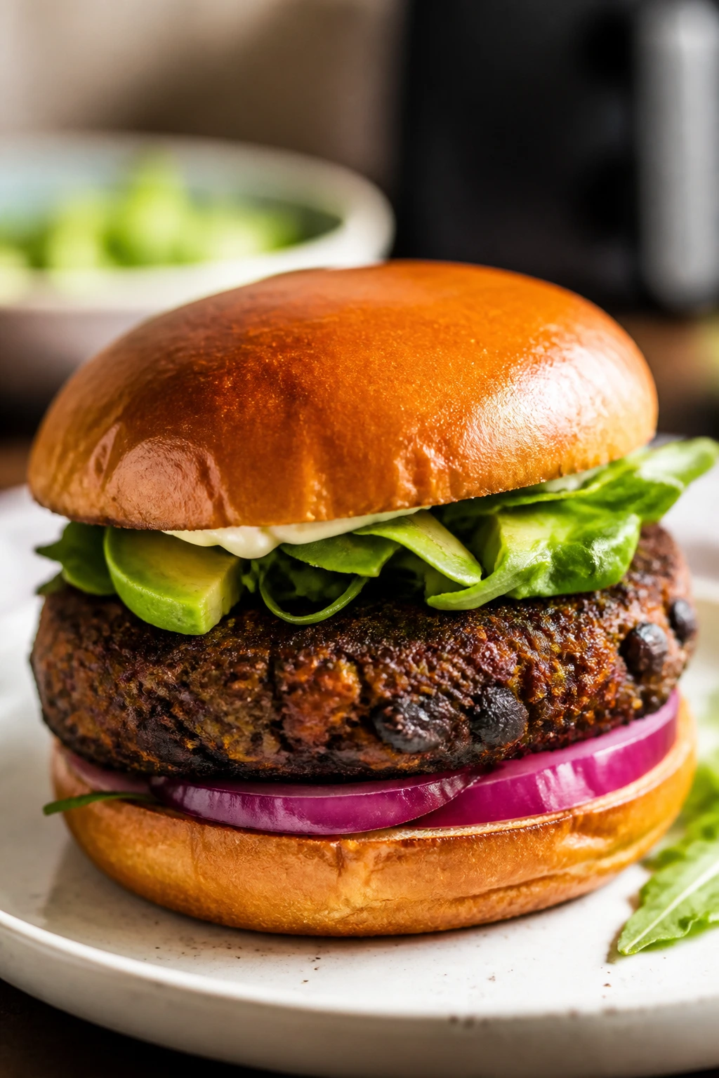 Close-up of a black bean burger patty on a bun.