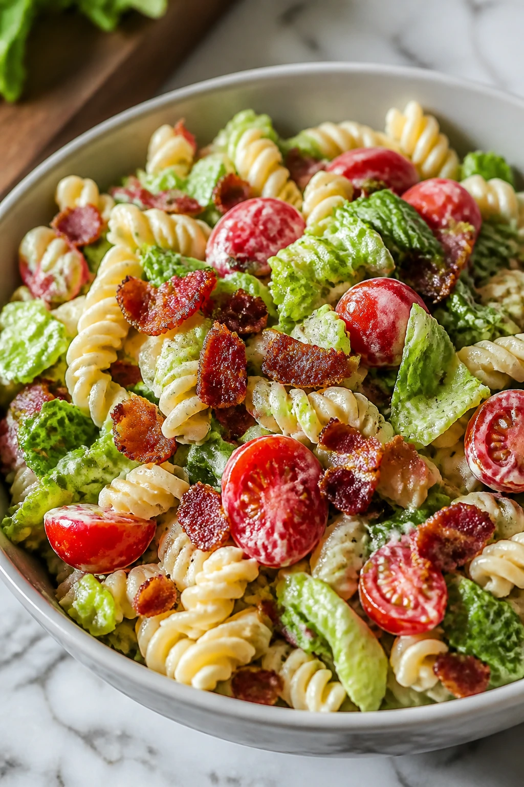 Close-up of BLT Pasta Salad with bacon, tomatoes, and romaine