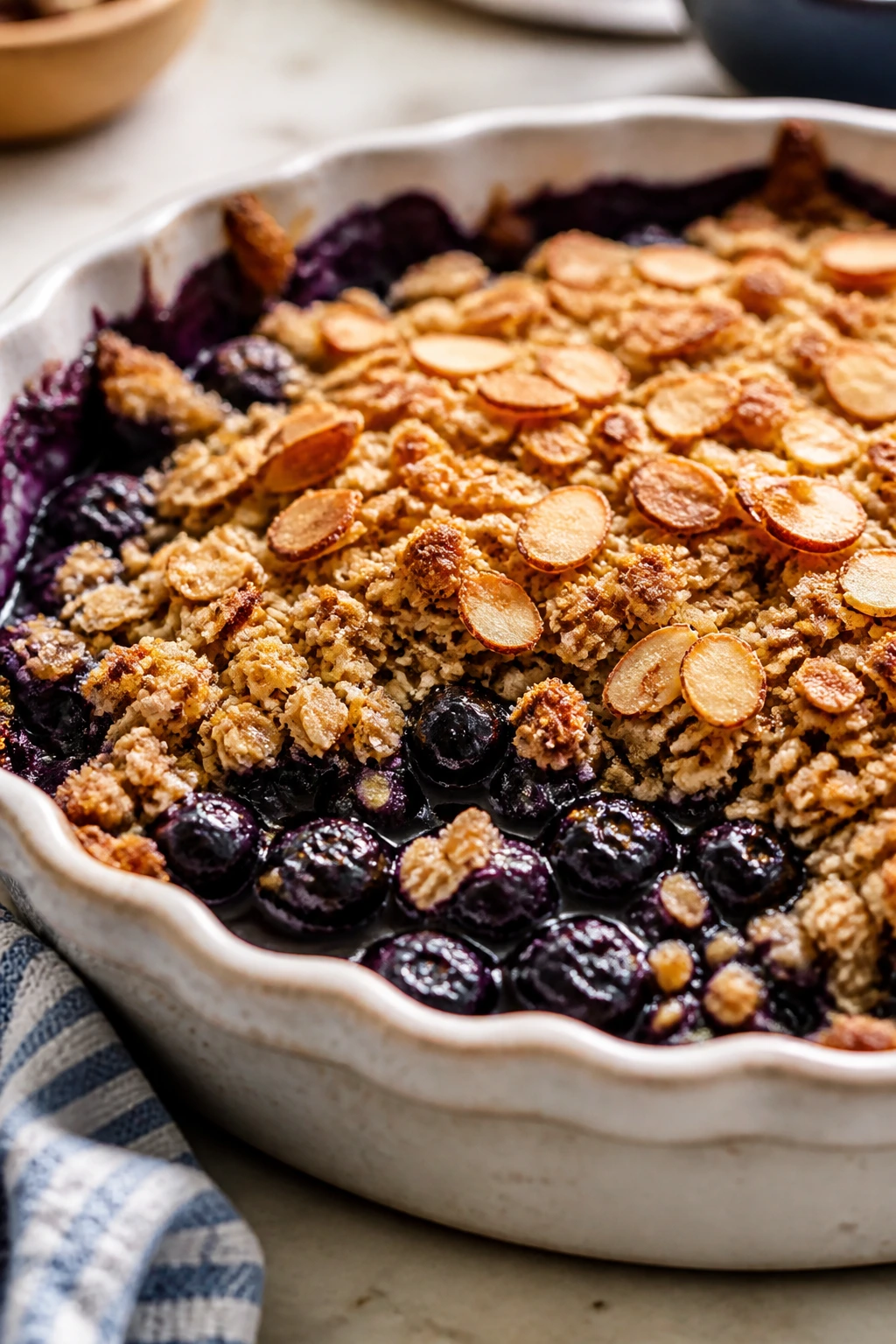 Blueberry almond crisp in a baking dish with almond topping
