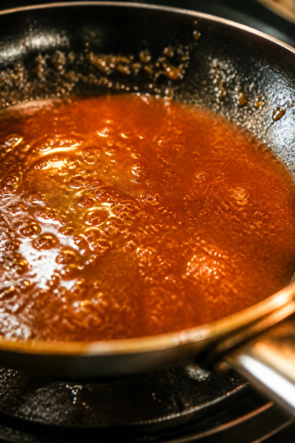 Close-up of glossy amber glaze in a skillet