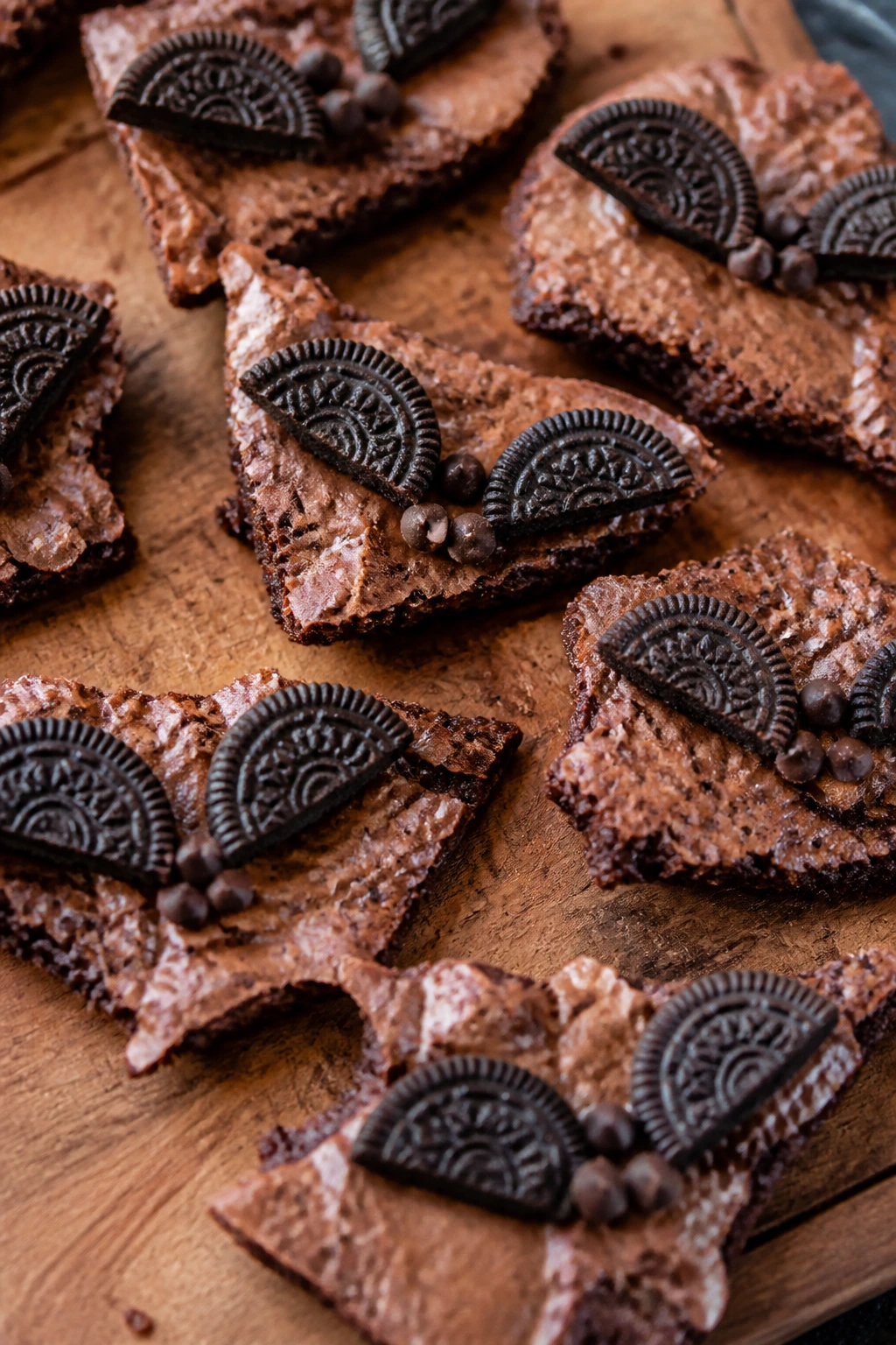 Close-up of irregular brownie bark with bat wings on a wooden board
