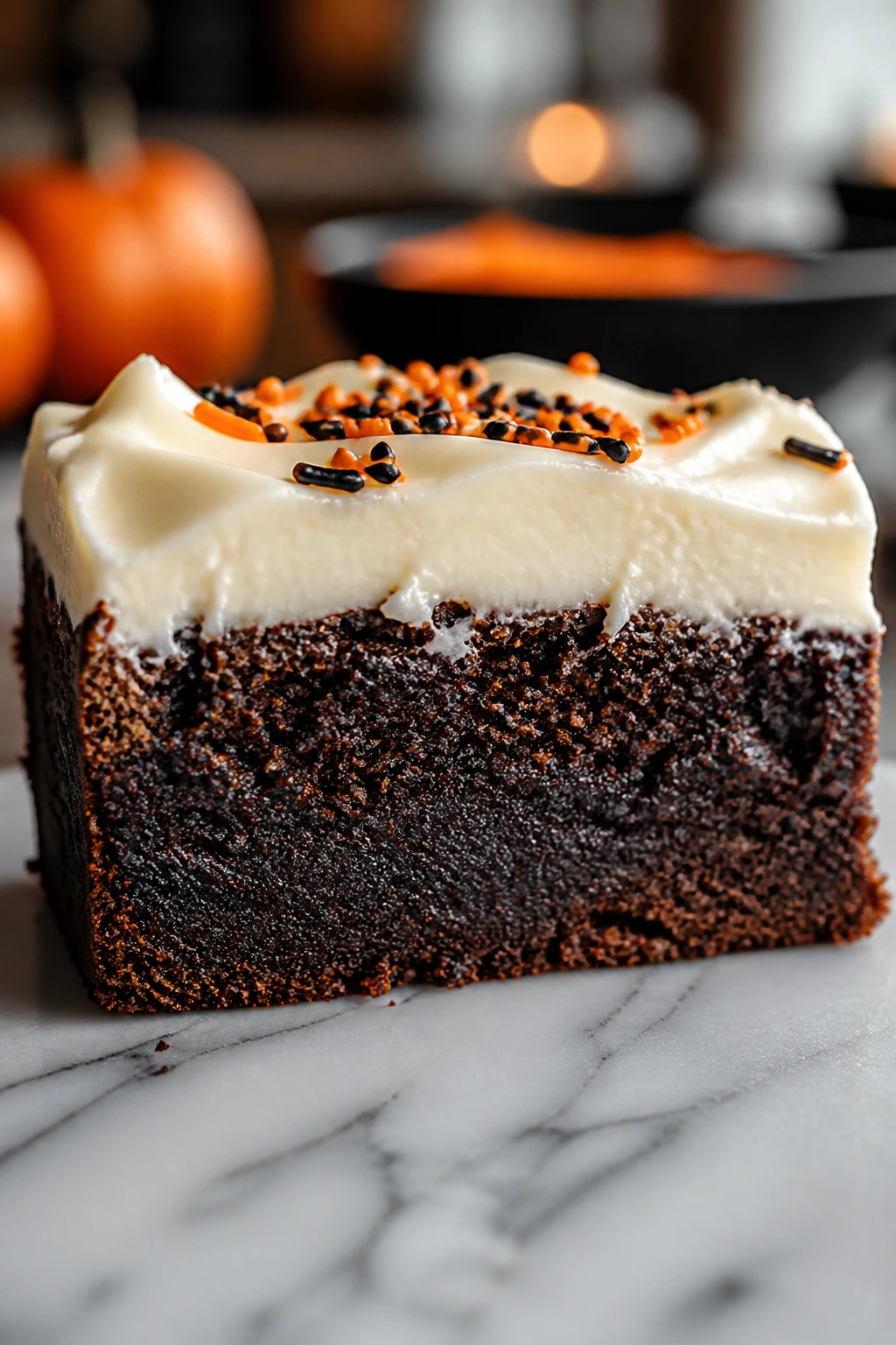 Cross-section of brownie slice with fudgy base and frosting