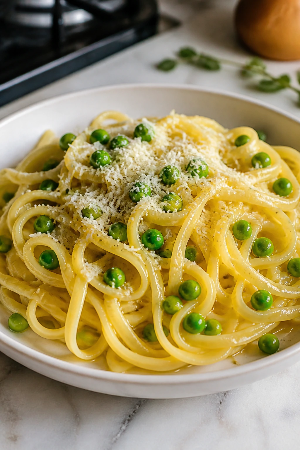 Close-up of buttered noodles with peas and parmesan