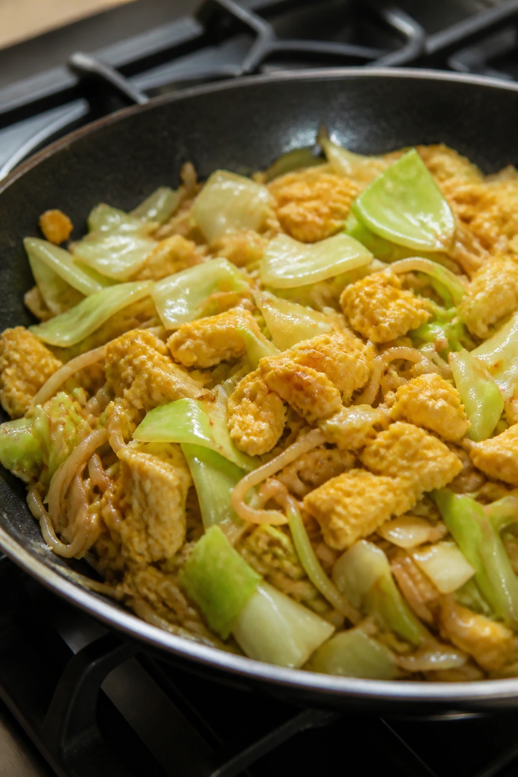 Cabbage noodle stir-fry with eggs in a skillet