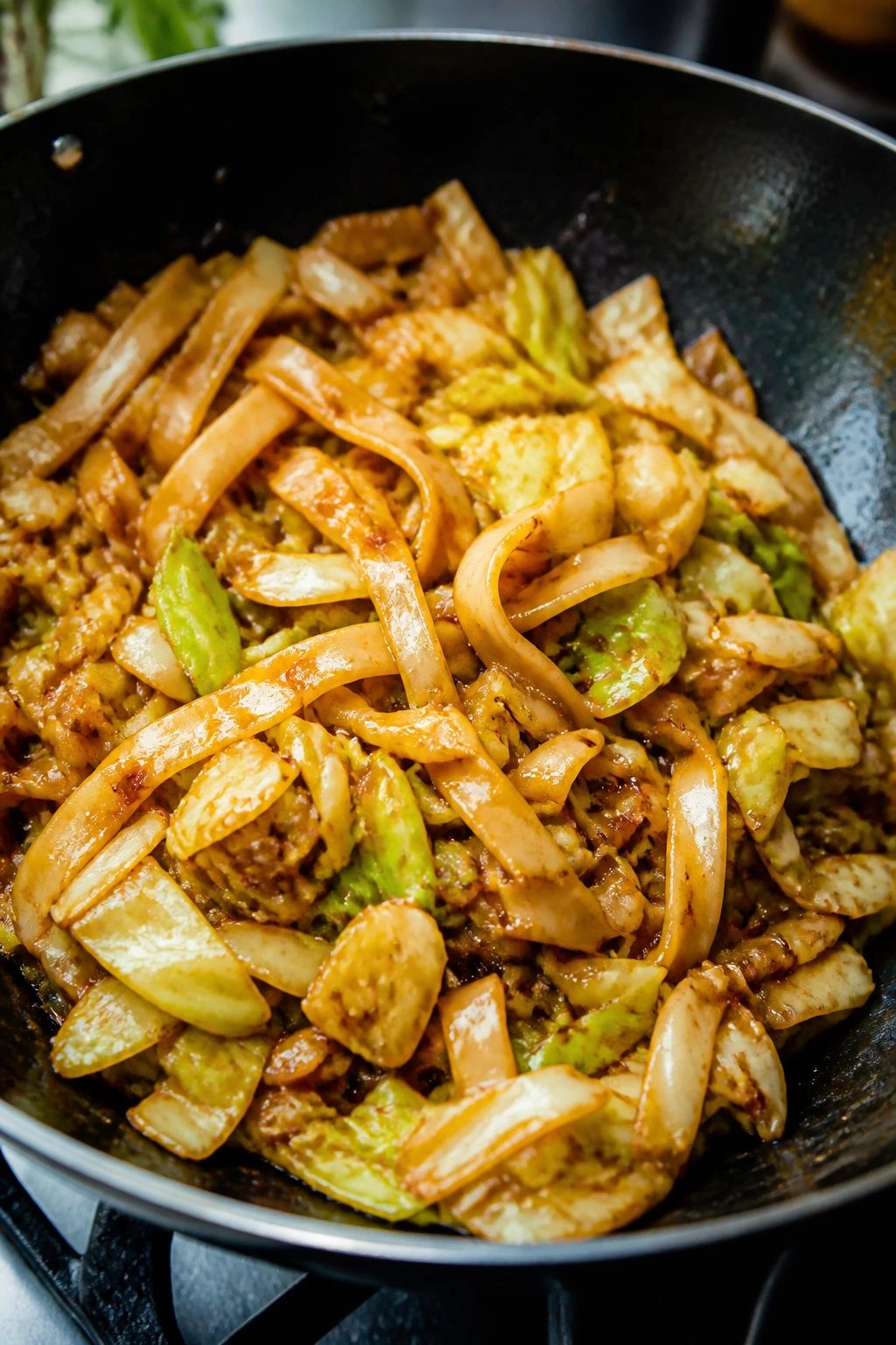 Cabbage and noodle stir-fry in a wok