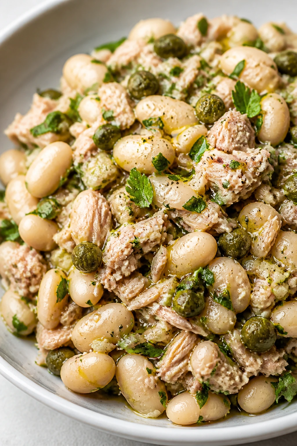 Cannellini bean tuna salad with parsley and capers in a bowl