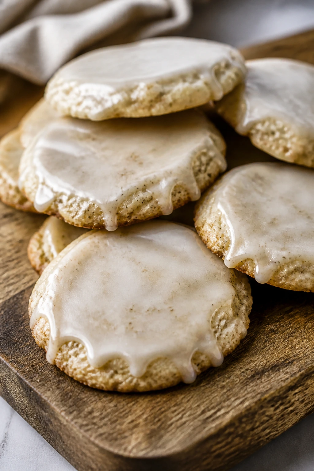 Chai-spiced sugar cookies with vanilla glaze on a wooden board