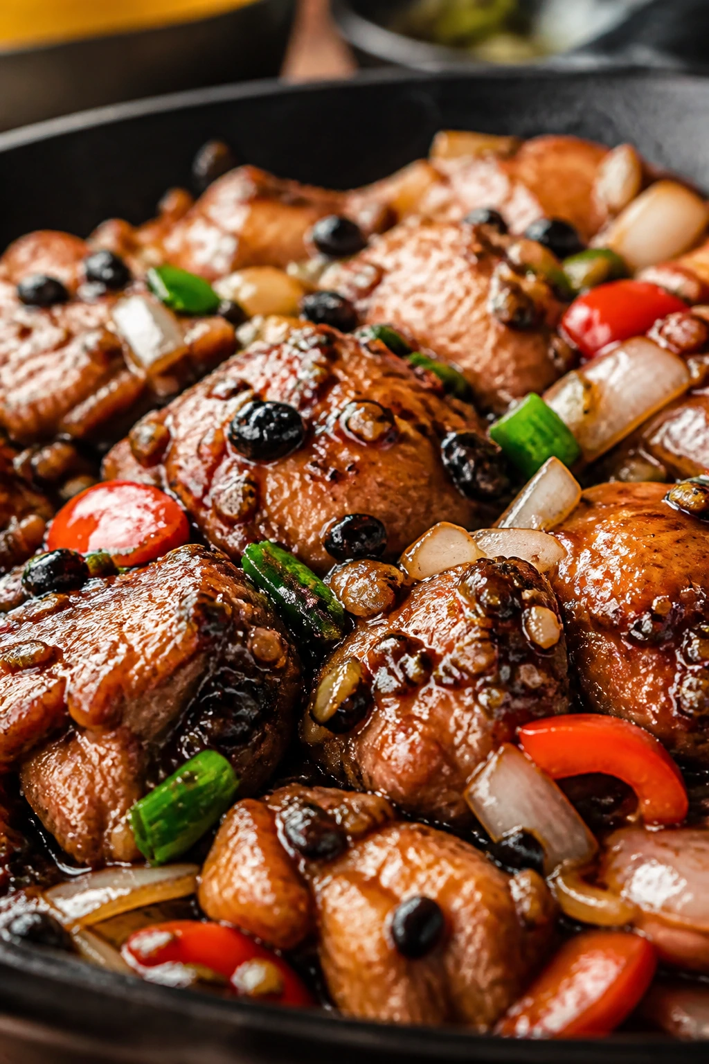 Close-up of Chicken with Black Bean Sauce in wok with vegetables