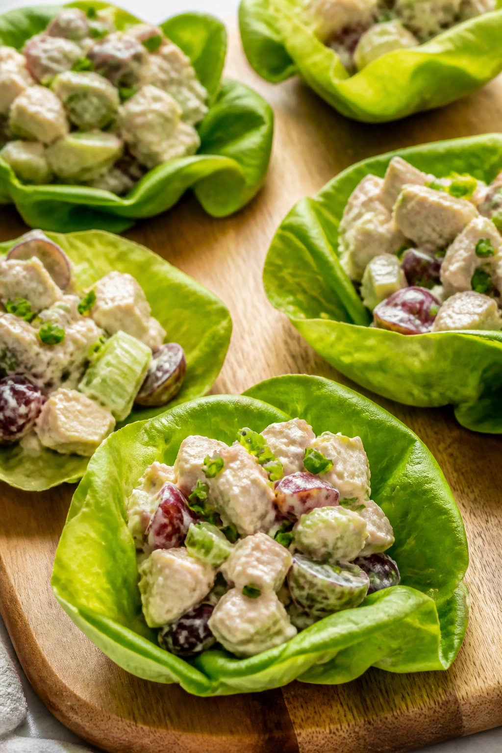 Chicken salad lettuce cups on wooden board