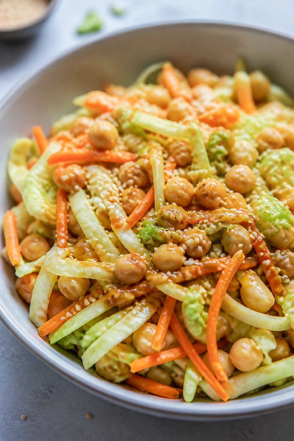 Close-up of Sesame Ginger Chickpea Crunch Salad with cabbage, carrots, and sesame seeds.