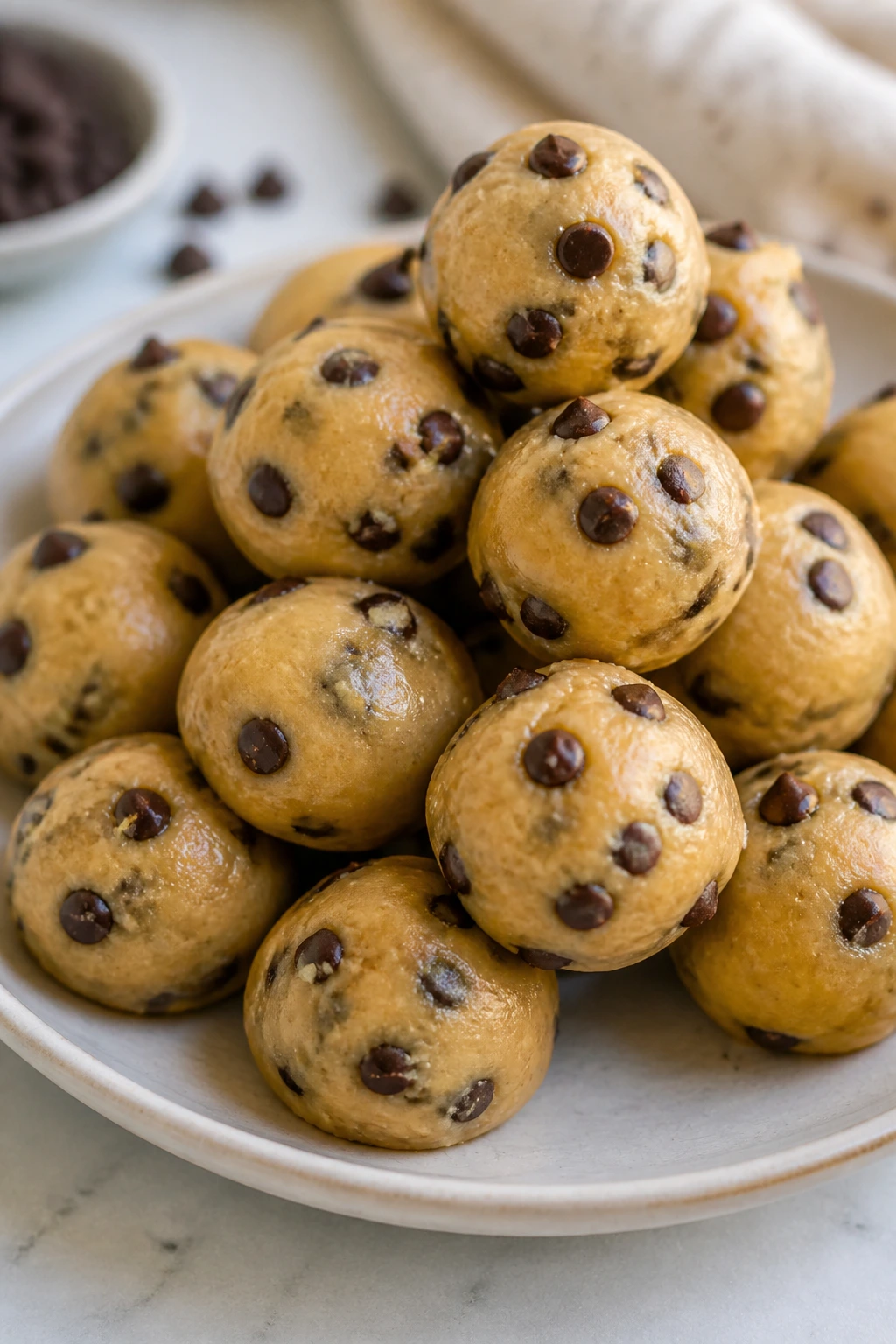 Plate of no-bake cookie dough bites on a kitchen counter