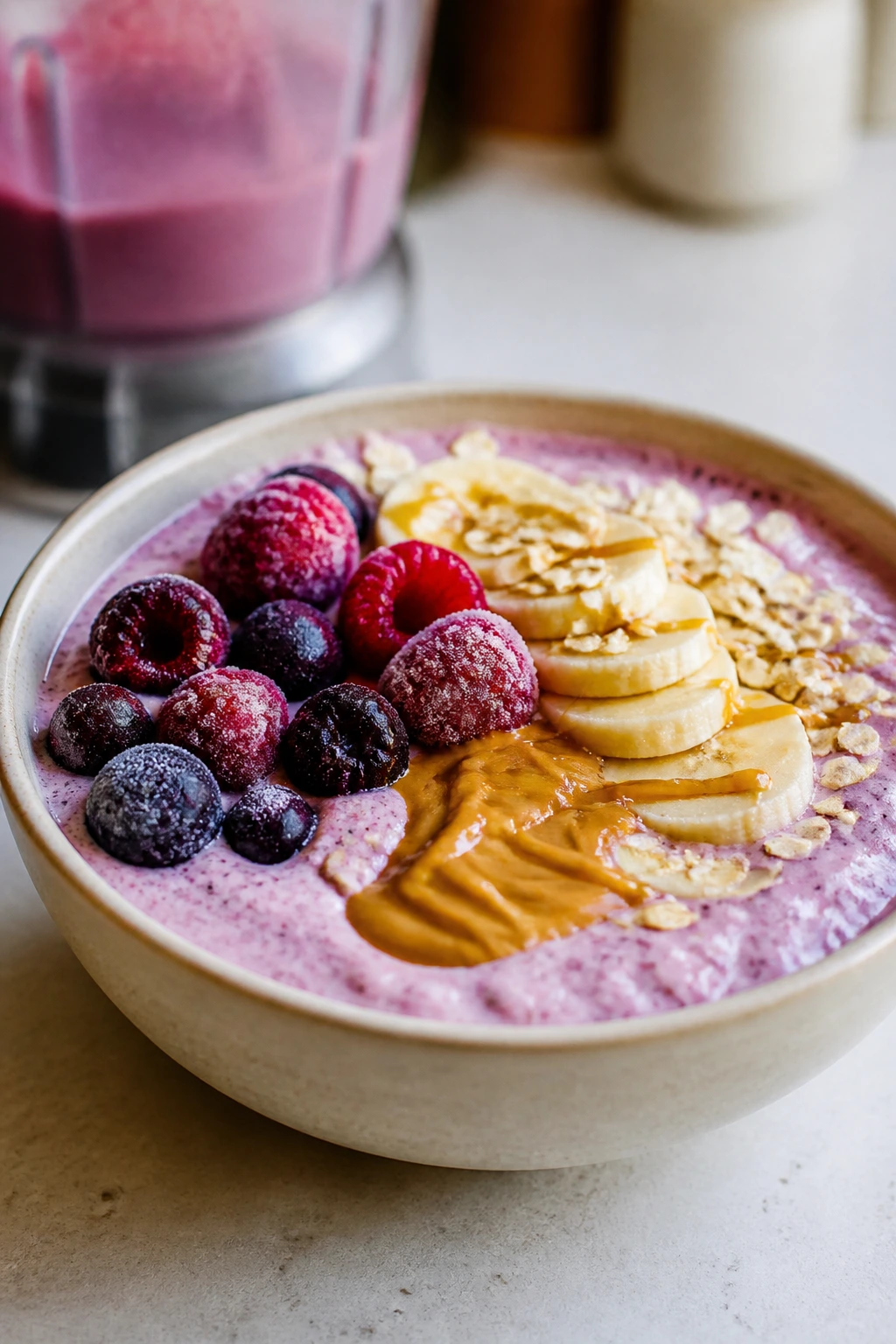 Thick cottage cheese smoothie bowl topped with berries and peanut butter