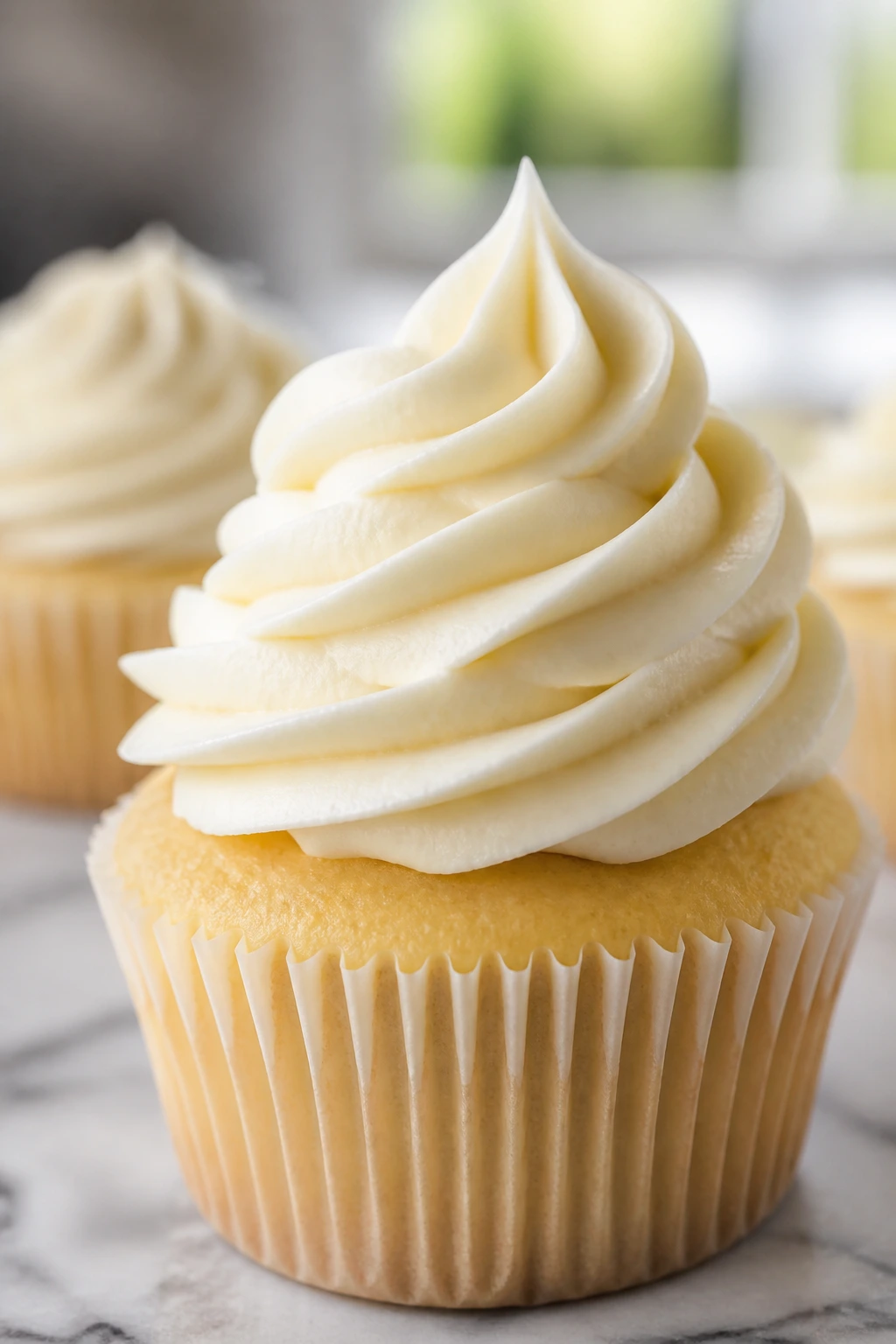 Close-up of a cream cheese frosting swirl on a cupcake