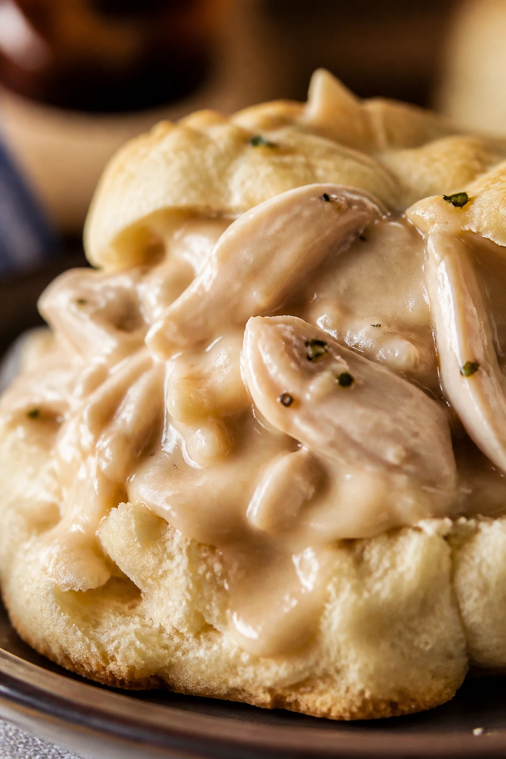 Split biscuit with creamed turkey and gravy on a warm kitchen table