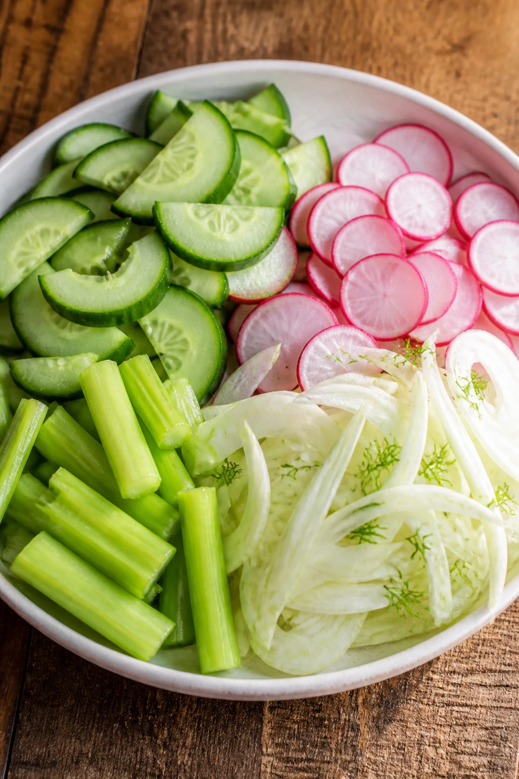 Crisp cucumber, radish, celery, and fennel on a plate