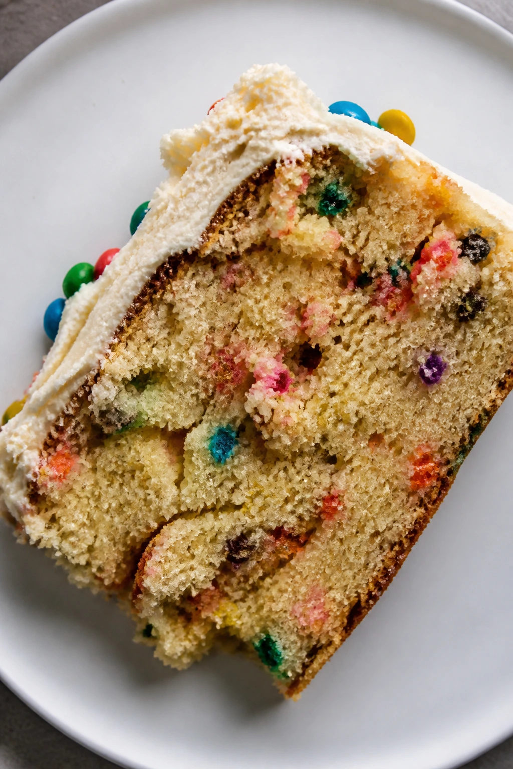 Dense crumb cake slice with rough frosting in a plate