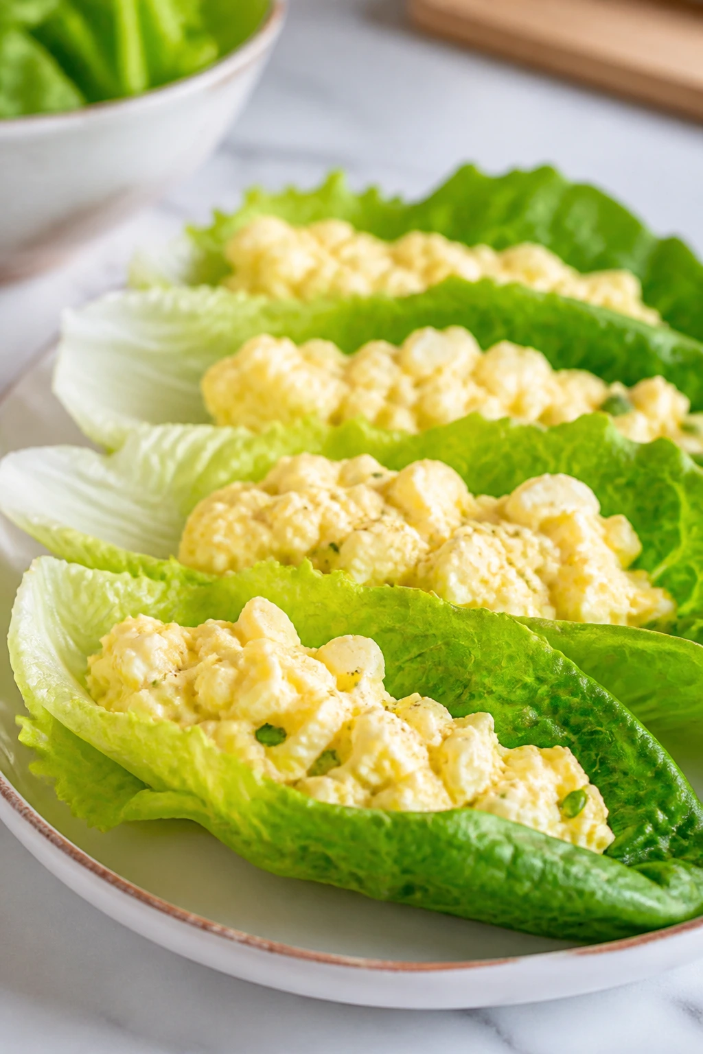 Lettuce leaves filled with egg salad on a plate