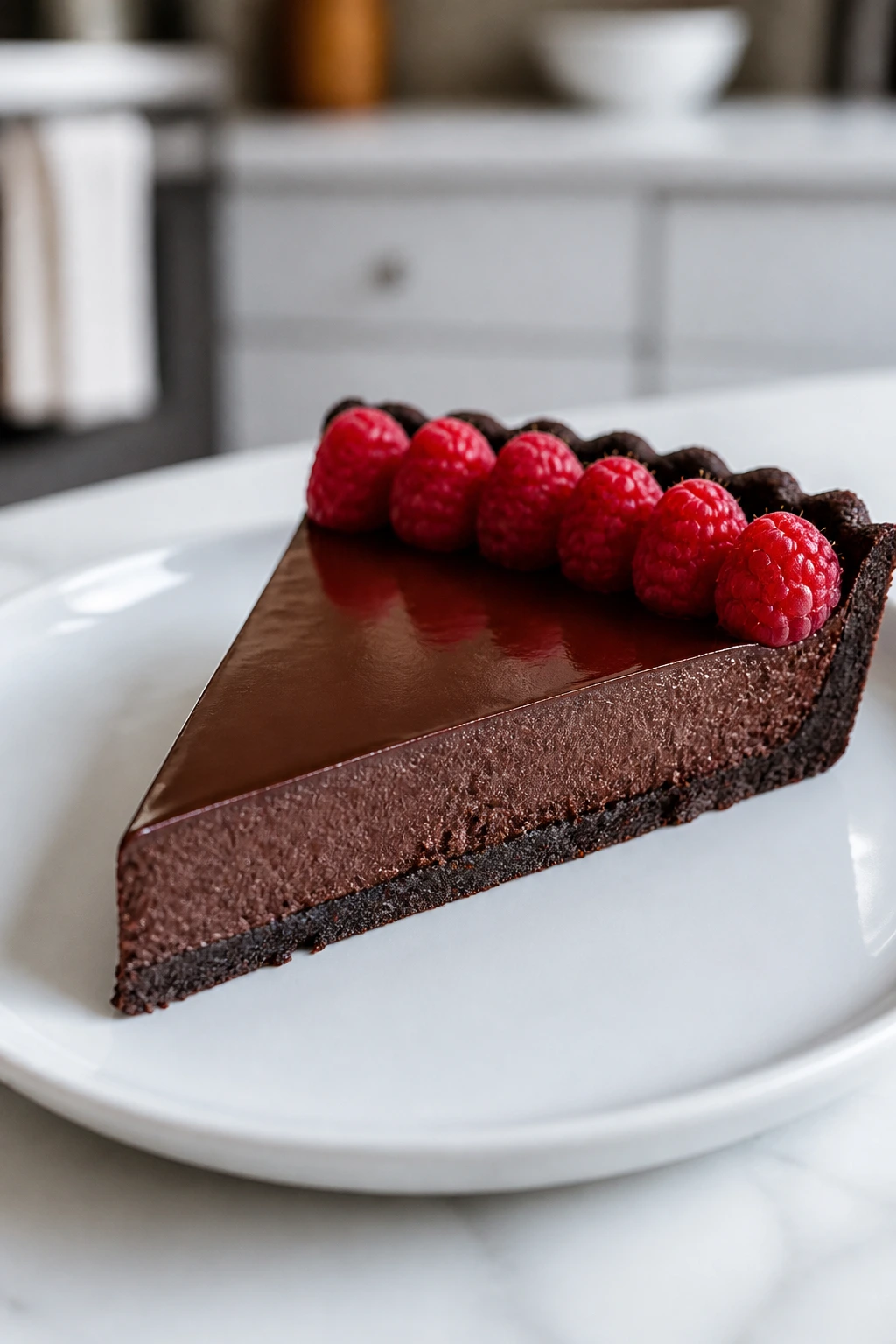 Midnight Espresso Tart slice with espresso-dark chocolate and raspberries