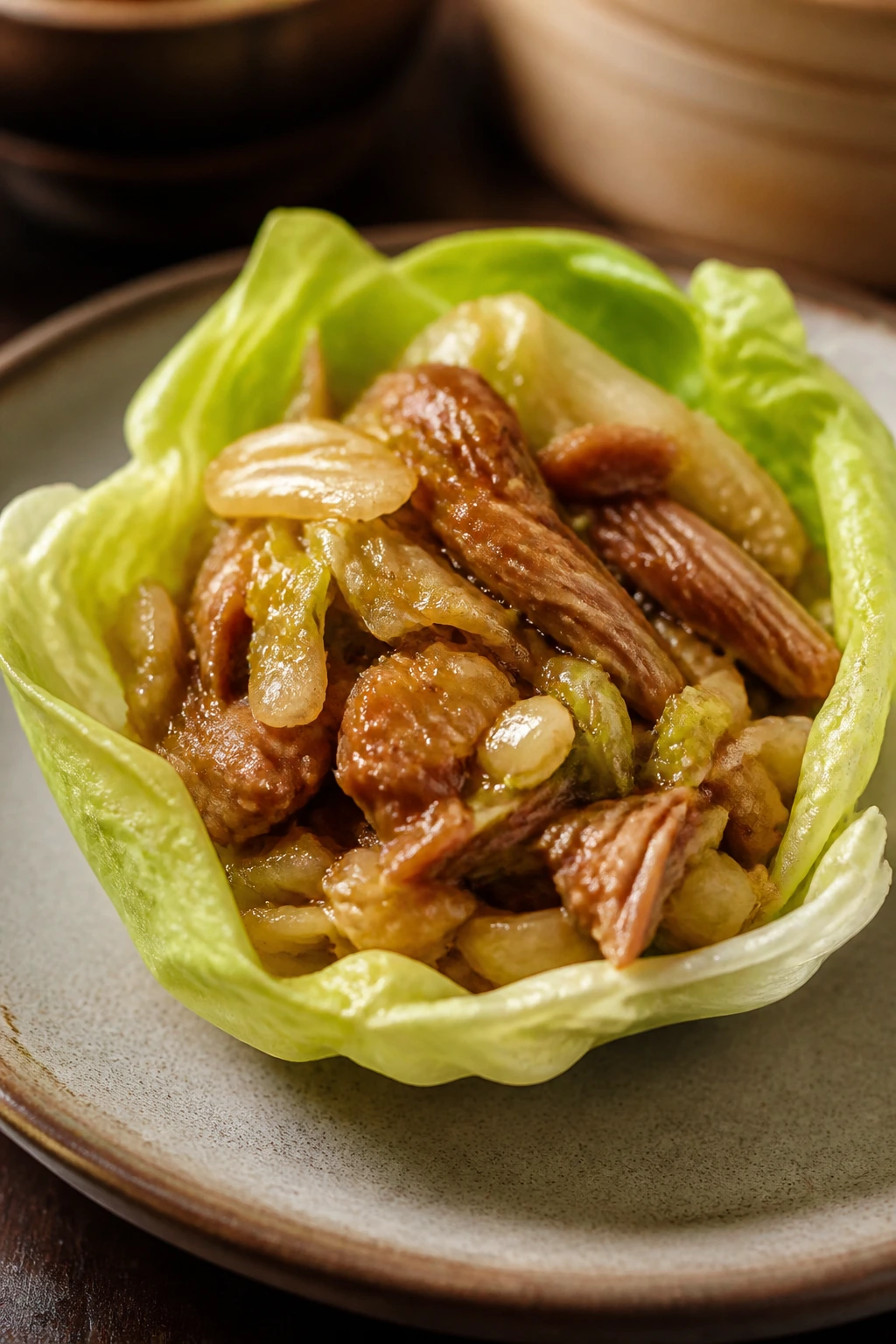 Close-up of a five-spice pork lettuce cup with napa cabbage