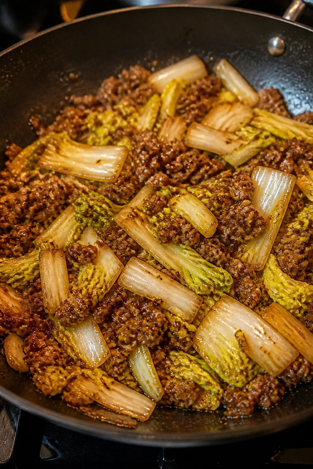 Close-up of five-spice pork with napa cabbage in a skillet