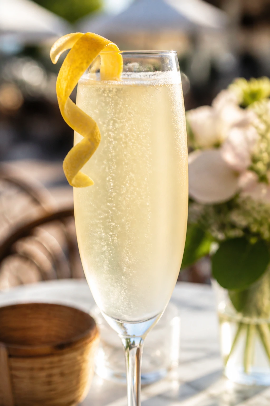 French 75 cocktail in a flute with lemon twist and bubbles
