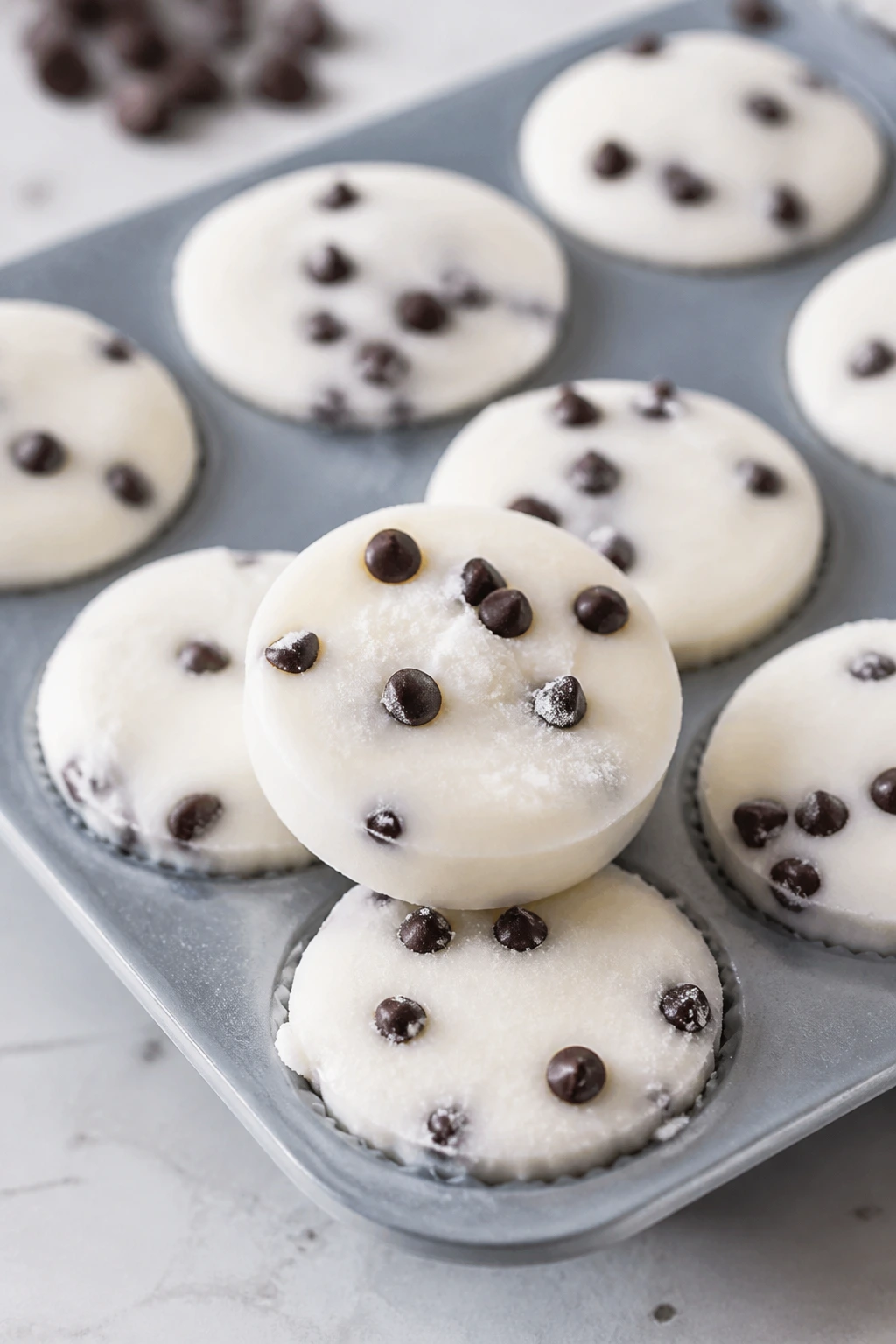 Close-up of frozen yogurt bites with chocolate chips in silicone molds