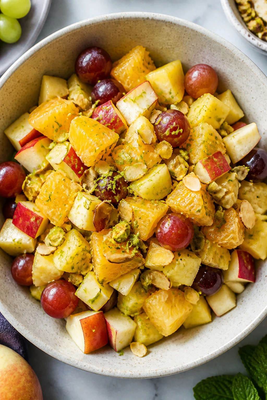 Fruit salad with nuts and lime zest topping