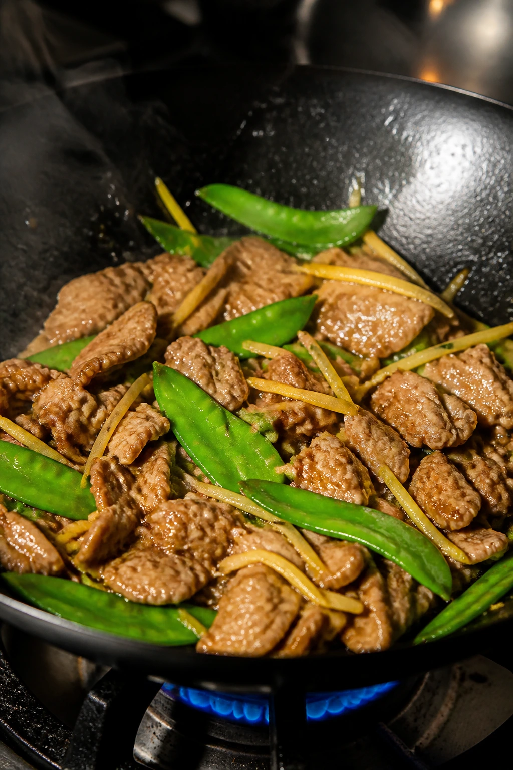 Ginger pork stir-fry with ginger slices and snow peas