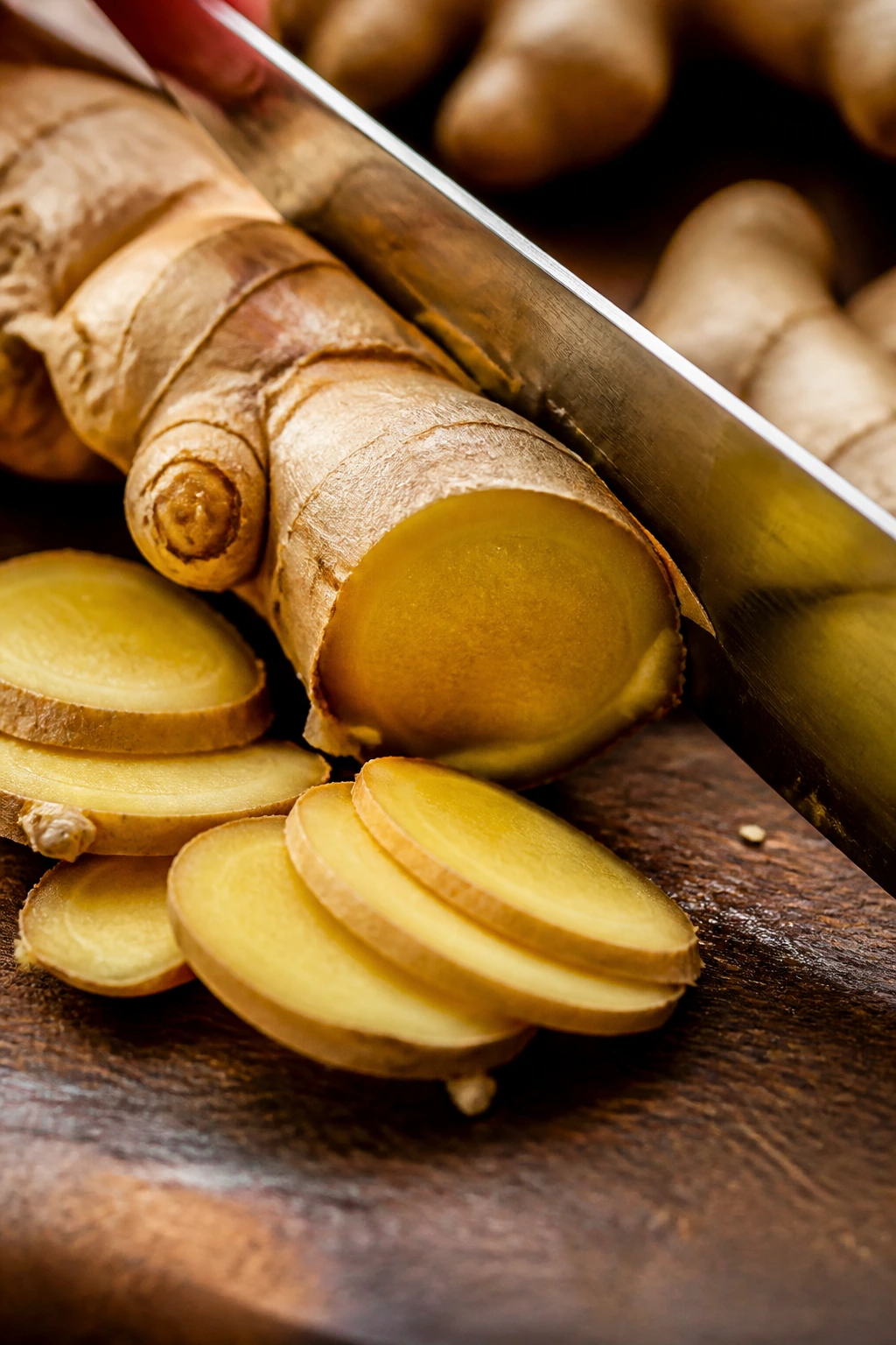 Fresh ginger root on cutting board, sliced for cooking