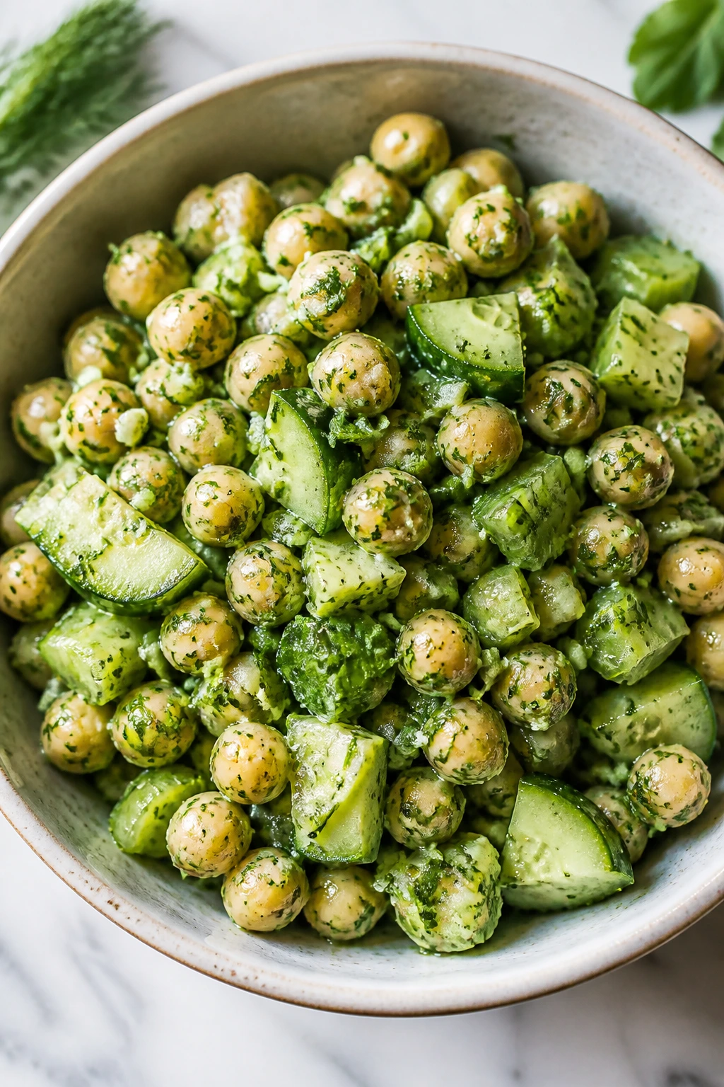 Close-up of green goddess chickpea salad in a bowl on a bright counter