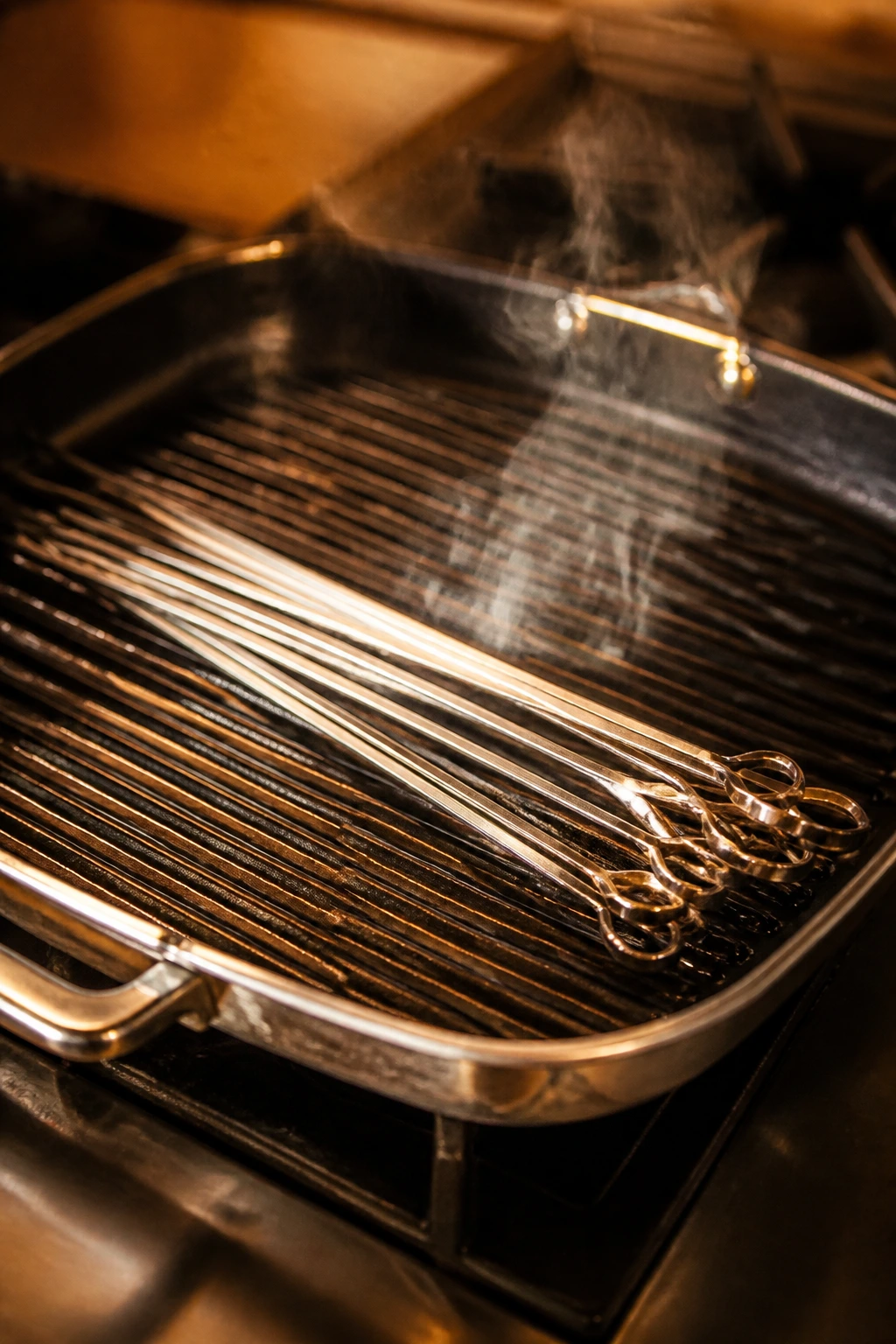 Grill pan with skewers resting across ridges