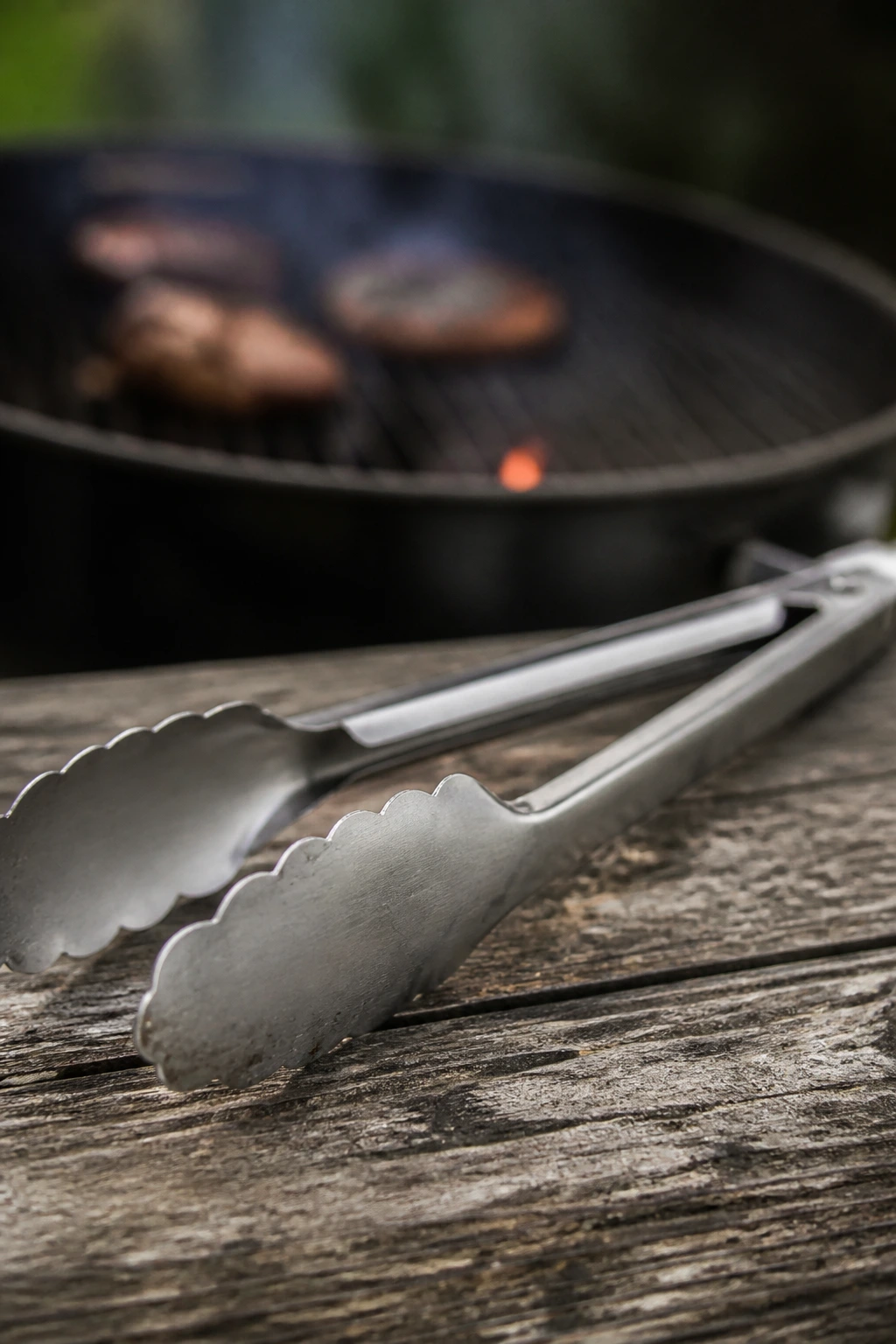 Close-up of long-handled grill tongs as essential BBQ tool