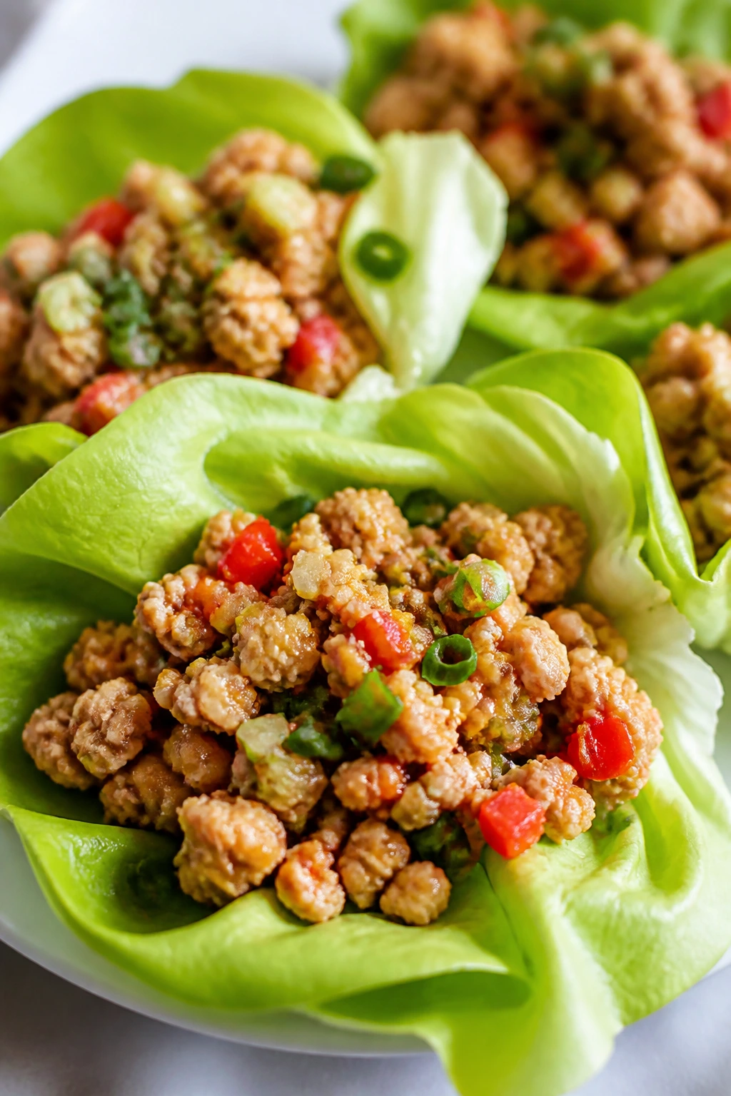 Lettuce cups with ground chicken filling on a kitchen counter