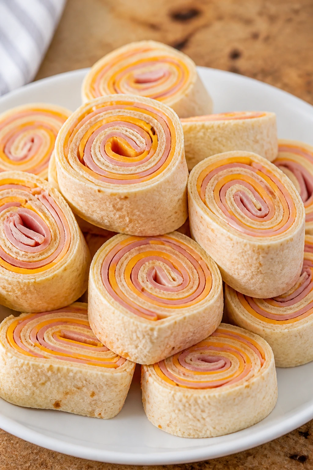 Ham and Cheese Pinwheels sliced to show spiral layers on a plate