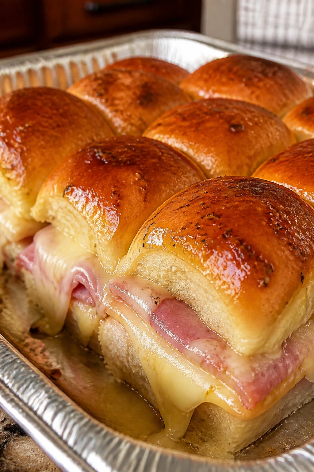 Close-up of ham and cheese sliders on a tray